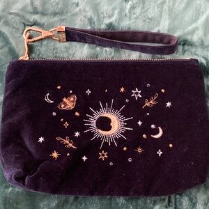 Elizabeth Scarlett navy celestial pouch with wrist strap.